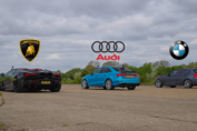 Tuned BMW M140i racing a Lamborghini Revuelto and Audi S3 during a high-horsepower drag race.