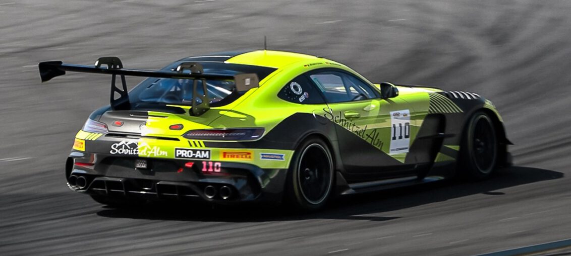 A Mercedes-AMG GT2 race car accelerates down the main straight at Monza Circuit during the GT2 European Series, showcasing its twin-turbo V8 performance.