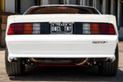 1991 Chevy Camaro restomod with a 525HP LS3 V8 engine driving on the road.