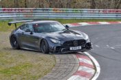 Car losing control at Adenauer Forst during a Nürburgring Nordschleife tourist drive, running wide onto the grass.
